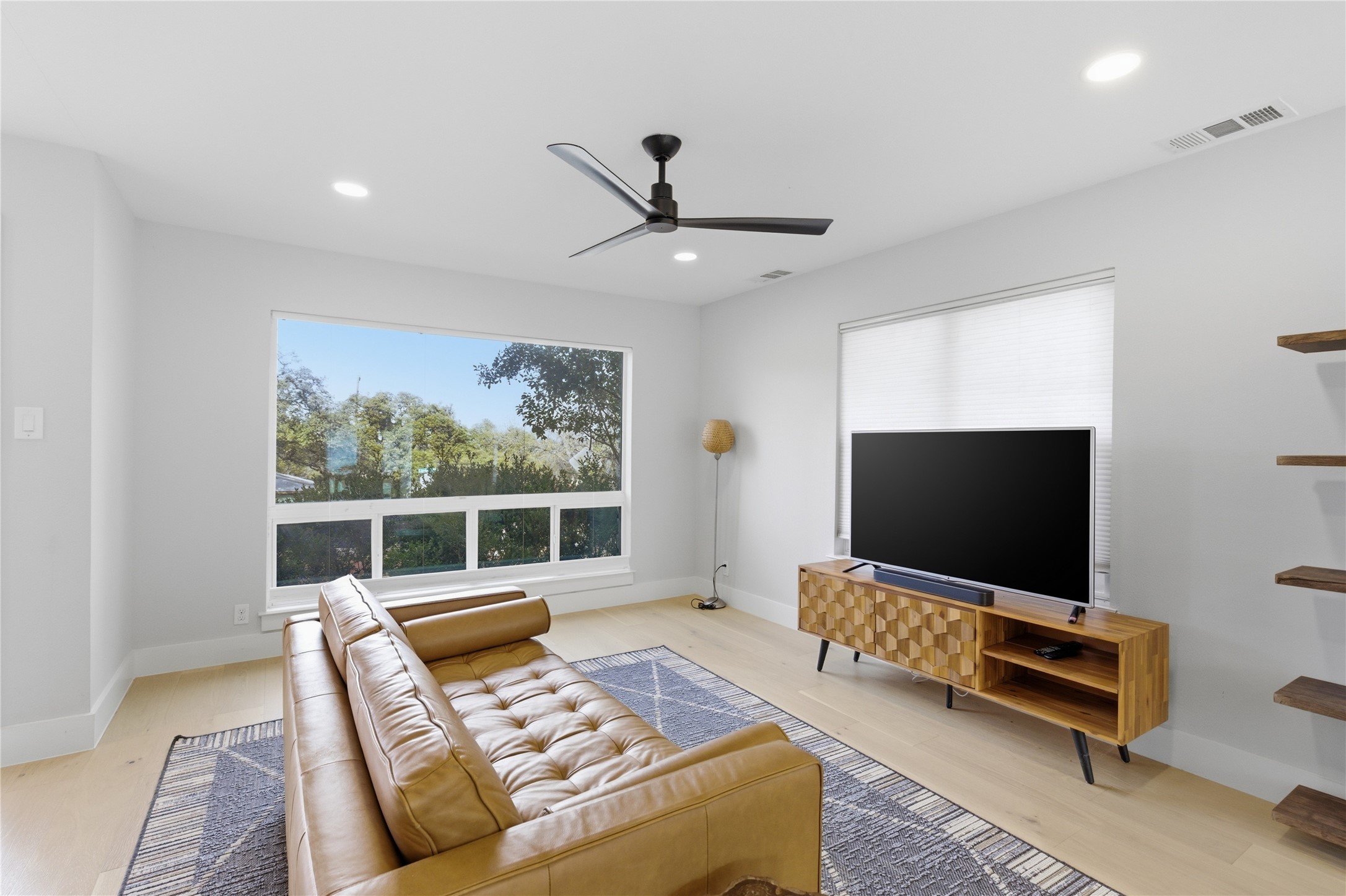 501 Lightsey Road Austin, TX 78704 - Photo 10 of 40 a living room with furniture and a flat screen tv
