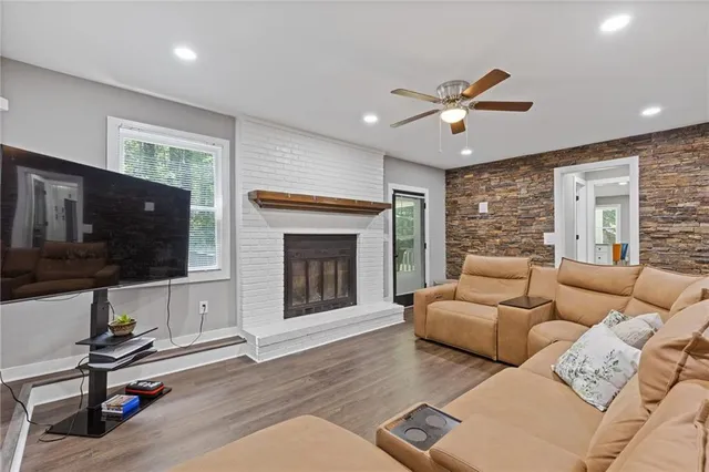 a bathroom with a granite countertop toilet a sink and a mirror