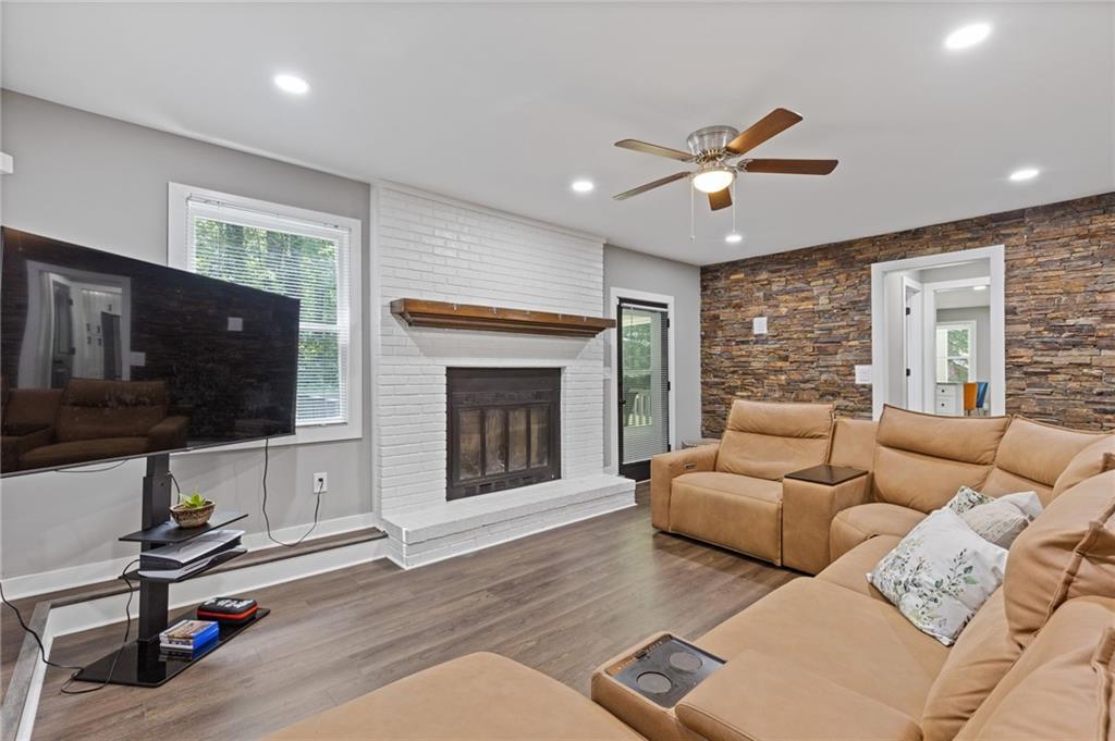 742 Mountain View Drive Stone Mountain, GA 30083 - Photo 14 of 43 a living room with furniture a flat screen tv and a fireplace