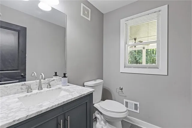 a kitchen with sink stove and wooden floor