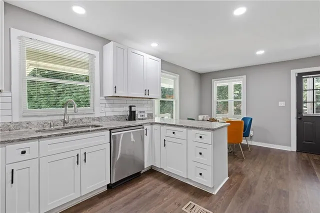 a kitchen with a stove a sink and a microwave