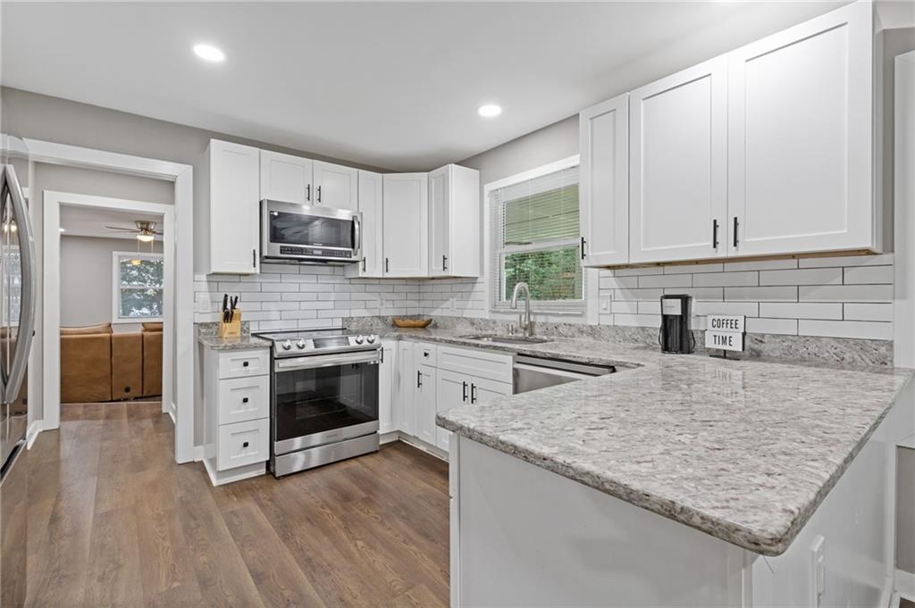 742 Mountain View Drive Stone Mountain, GA 30083 - Photo 17 of 43 a kitchen with a stove a sink and a microwave