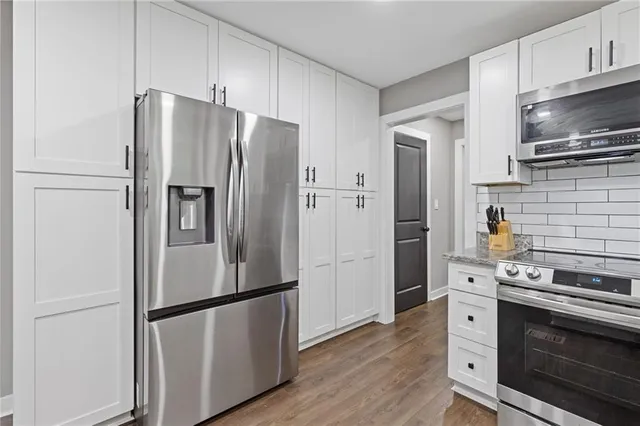 a dining room with furniture and wooden floor