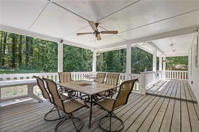 a view of a balcony with wooden floor and fence