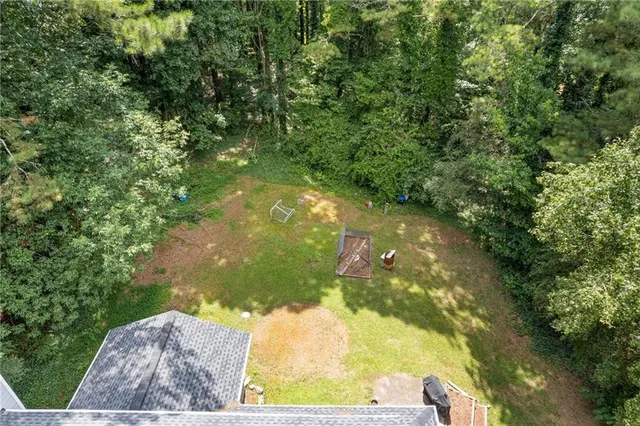an aerial view of a house with a yard table and chairs
