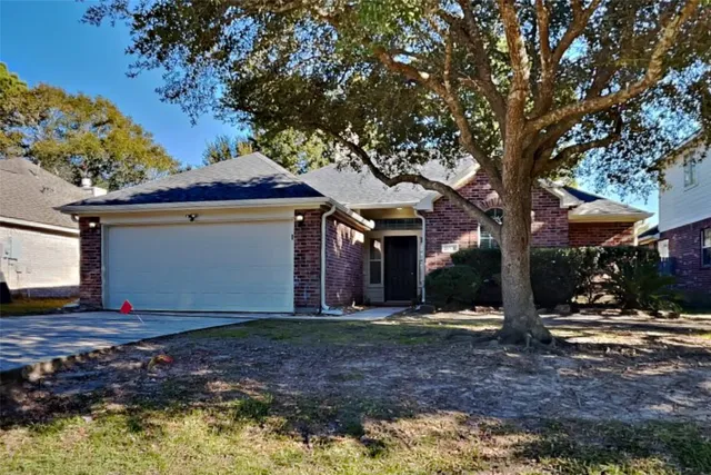 a view of a house with a tree and yard