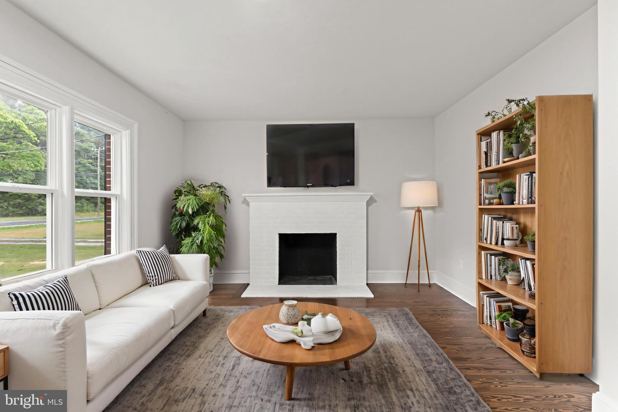 10221 Dahlgren Road King George, VA 22485 - Photo 2 of 31 a living room with furniture a bookshelf and a fireplace