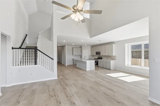 a view of a livingroom with furniture a ceiling fan and window