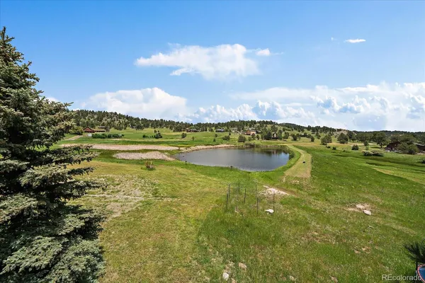 a view of a lake with houses in the back