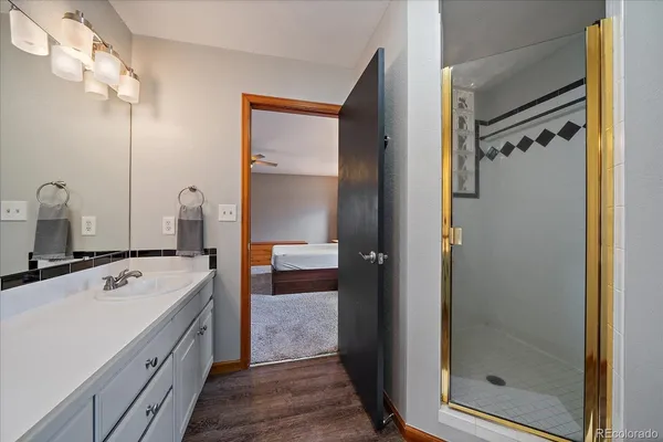 a bathroom with a tub sink vanity and mirror