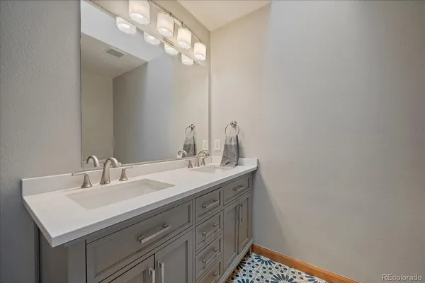 a bathroom with a sink vanity and a mirror