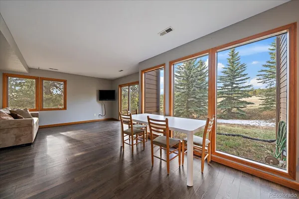 a view of a dining room with furniture and wooden floor