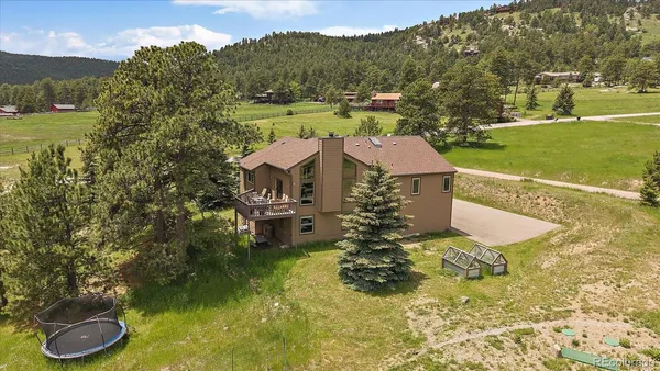 a view of a house with a yard and a large pool