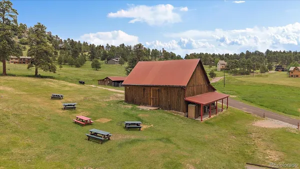 an aerial view of a house with backyard space and lake view
