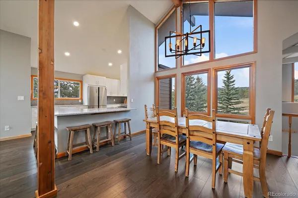 a dining room with furniture a rug and wooden floor