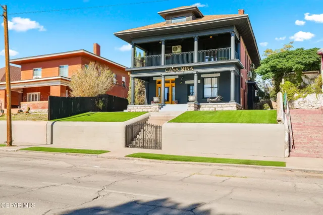 a front view of a house with a garden and plants