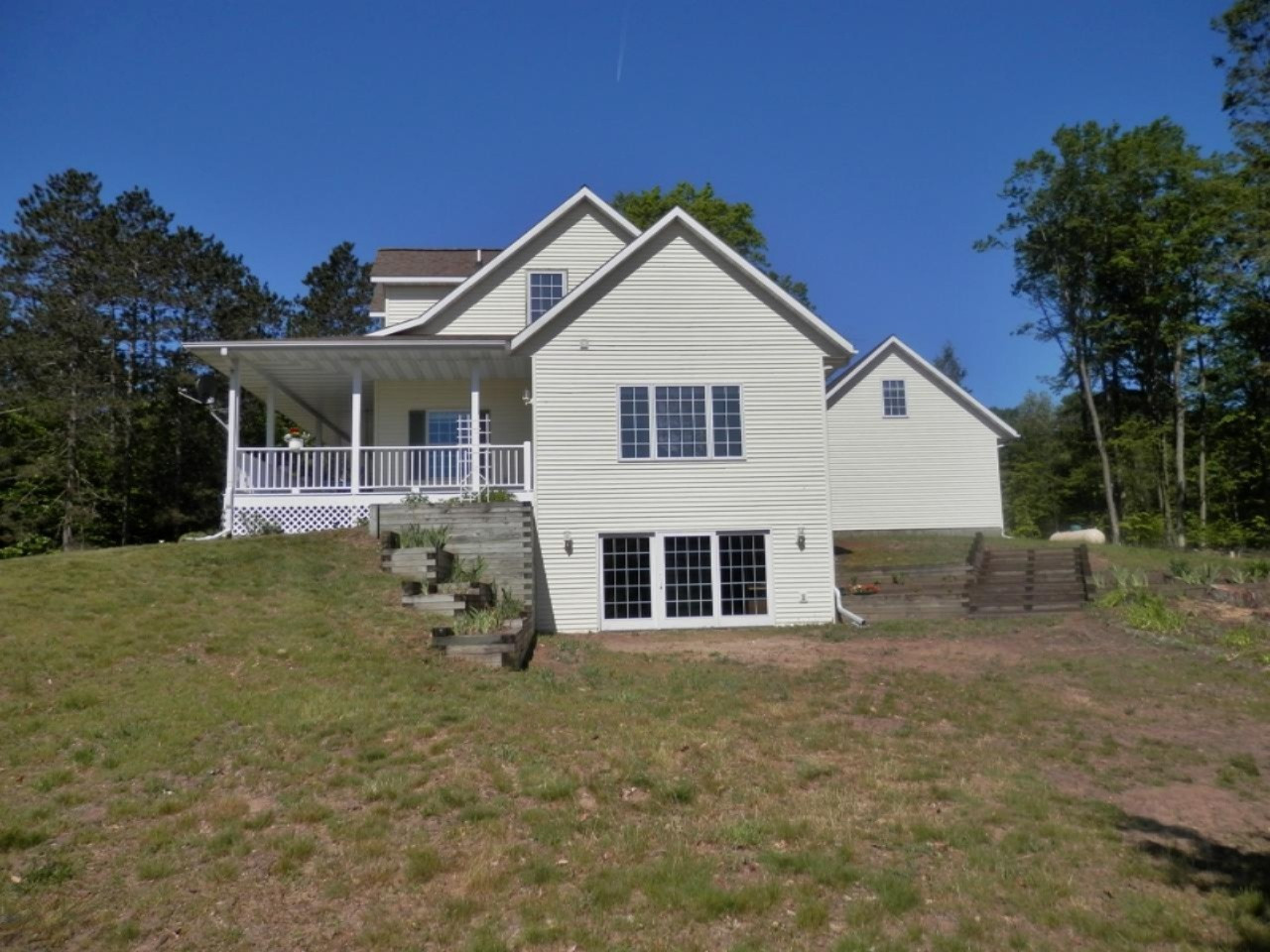 22296 Benton Road Mesick, MI 49668 - Photo 42 of 56 Side view walk-out terracing