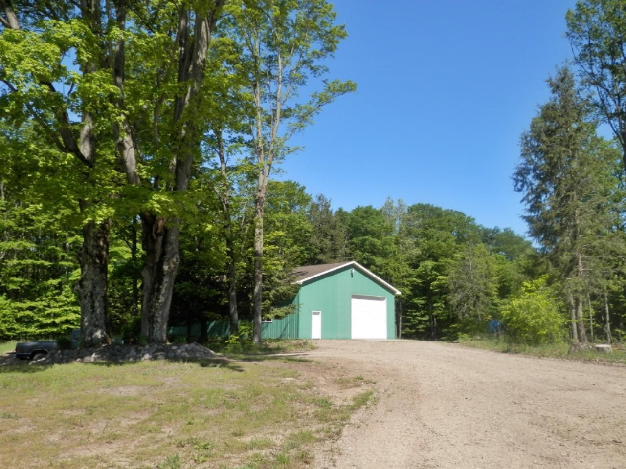 22296 Benton Road Mesick, MI 49668 - Photo 43 of 56 Beautiful hardwoods around pole barn