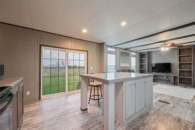 a kitchen with a table chairs refrigerator and cabinets