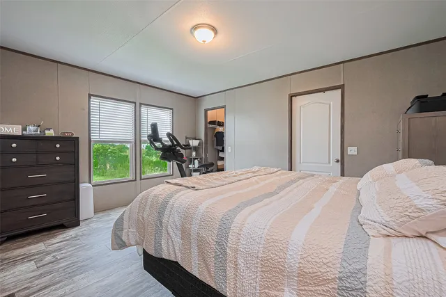 a bedroom with a bed and a dresser