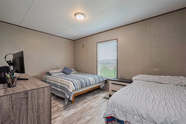 a bedroom with a bed and a desk