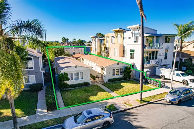 a aerial view of a house with swimming pool garden and tall buildings