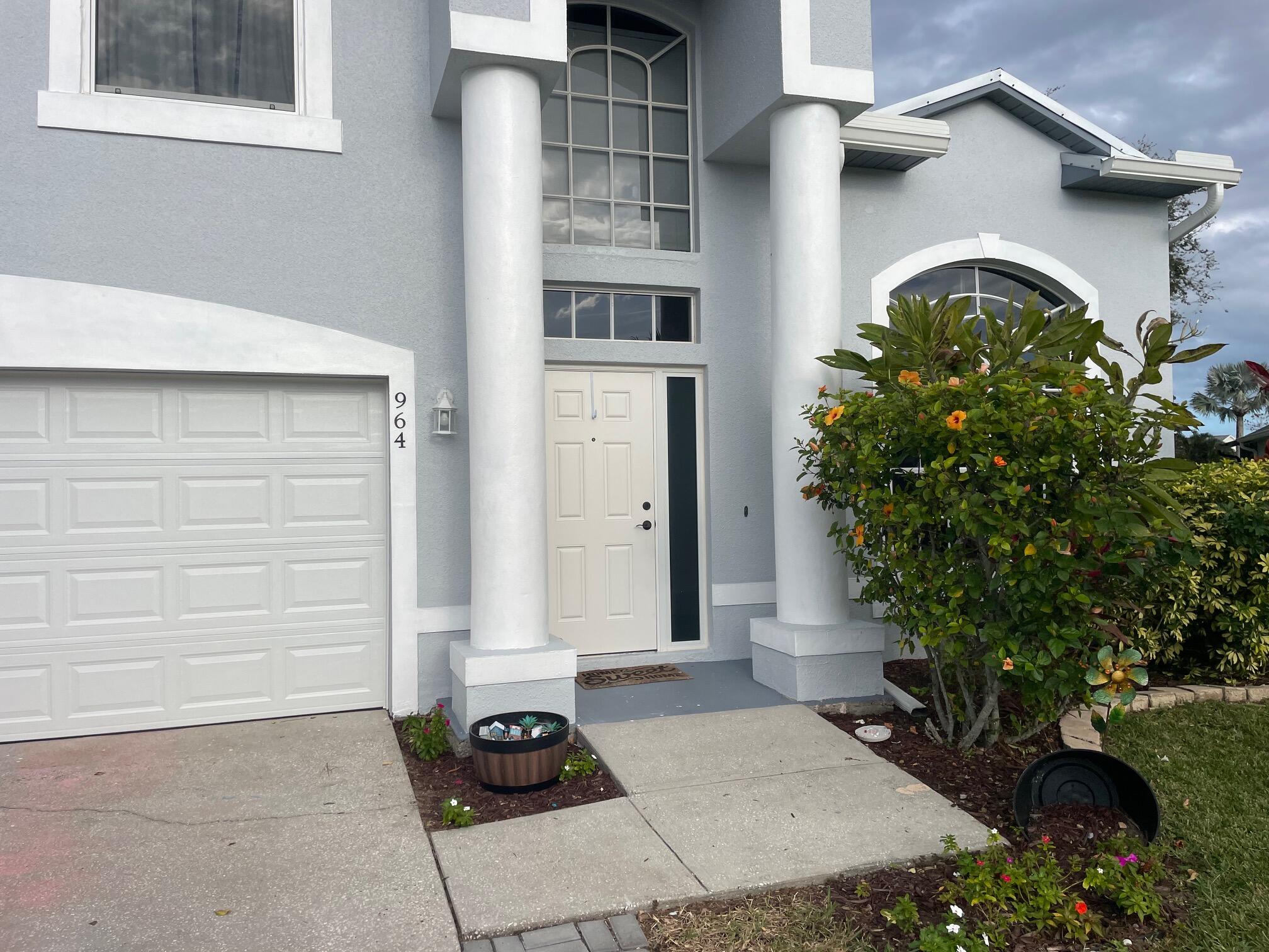 964 Shaw Circle Melbourne, FL 32940 - Photo 16 of 54 a front view of a house with a yard