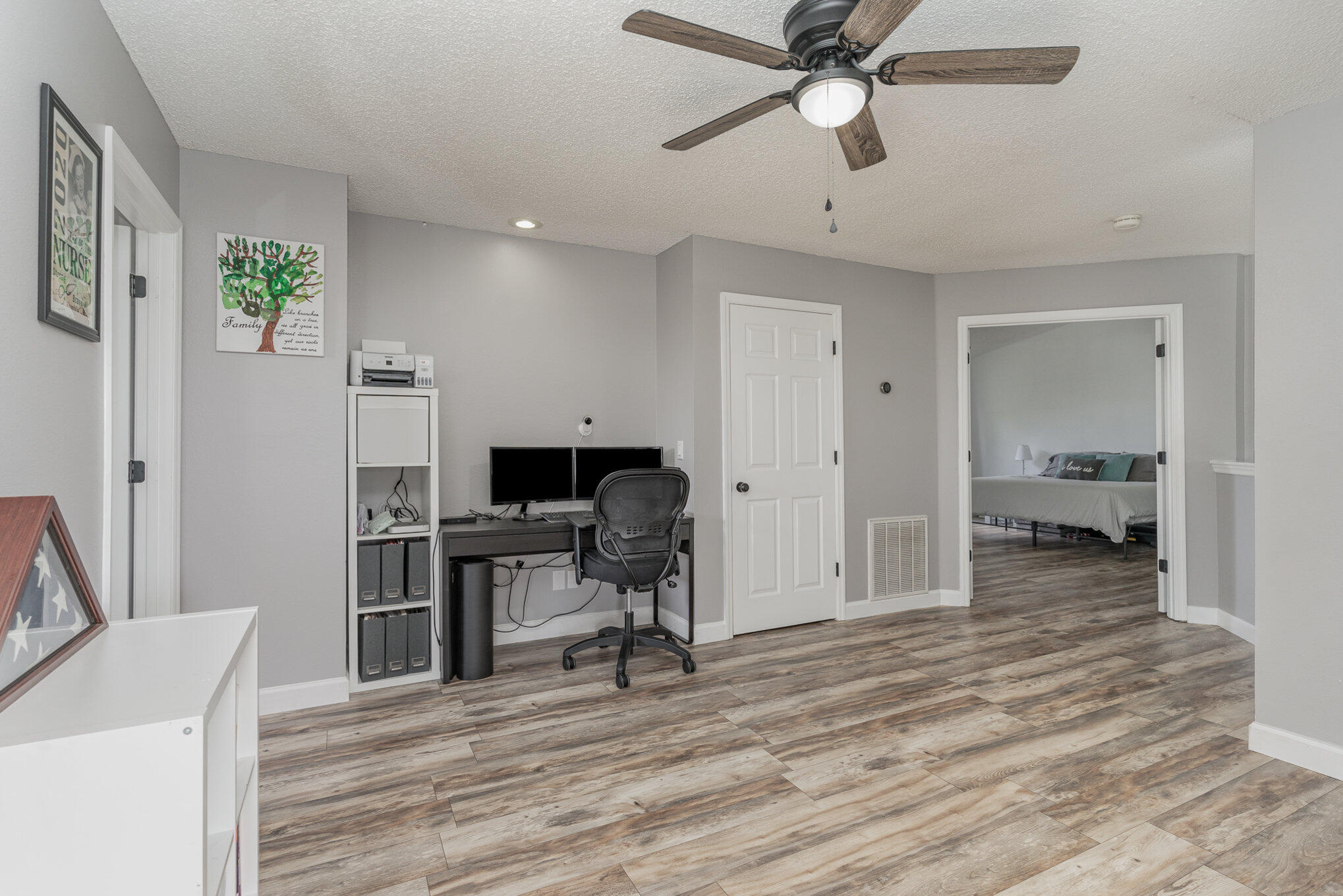 964 Shaw Circle Melbourne, FL 32940 - Photo 19 of 54 a view of a workspace with furniture and a ceiling fan