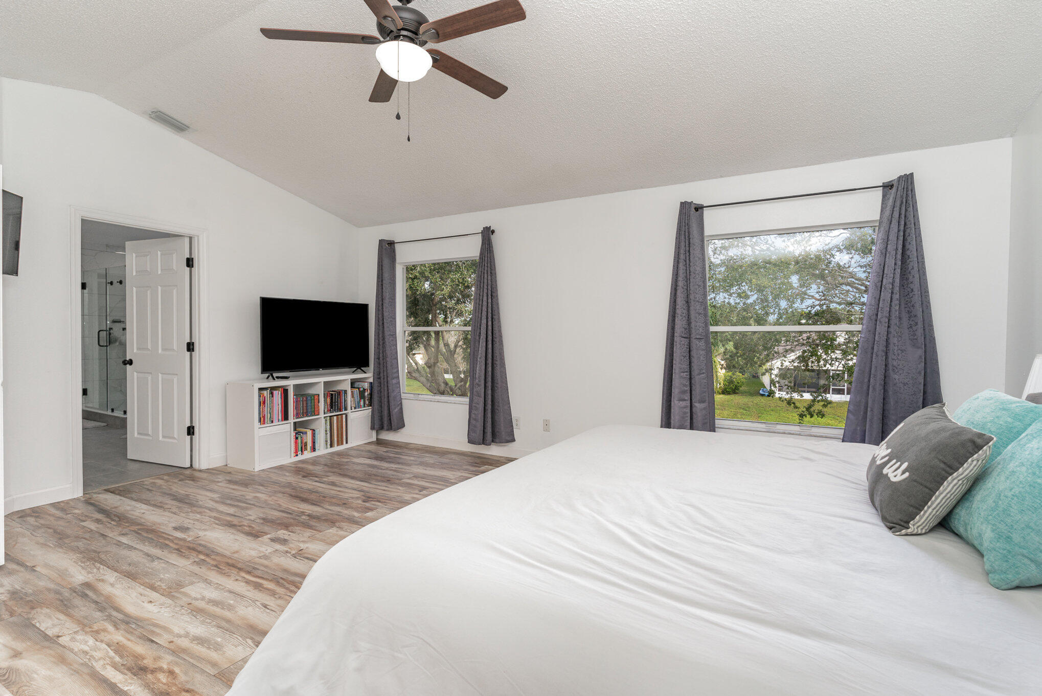 964 Shaw Circle Melbourne, FL 32940 - Photo 20 of 54 a bedroom with a bed and a flat screen tv