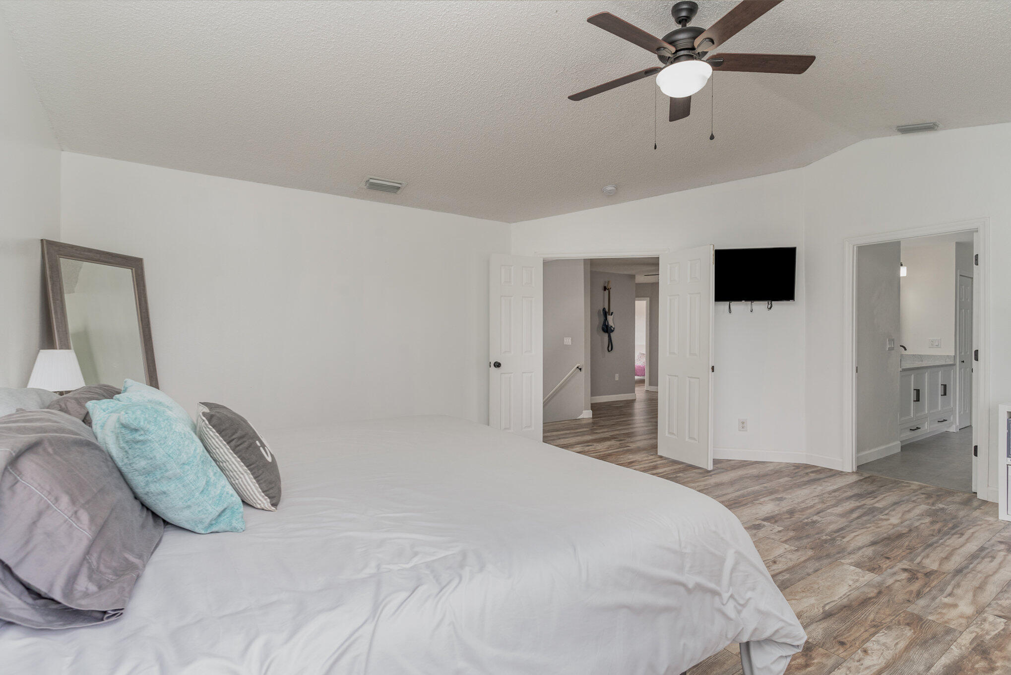 964 Shaw Circle Melbourne, FL 32940 - Photo 23 of 54 a bedroom with a large bed and a chandelier