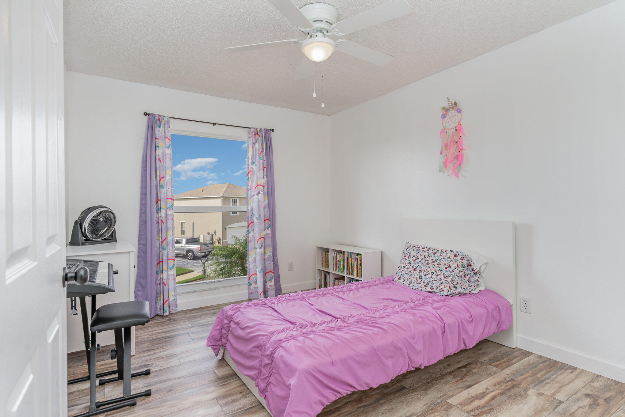 964 Shaw Circle Melbourne, FL 32940 - Photo 26 of 54 a bedroom with a bed and a chandelier