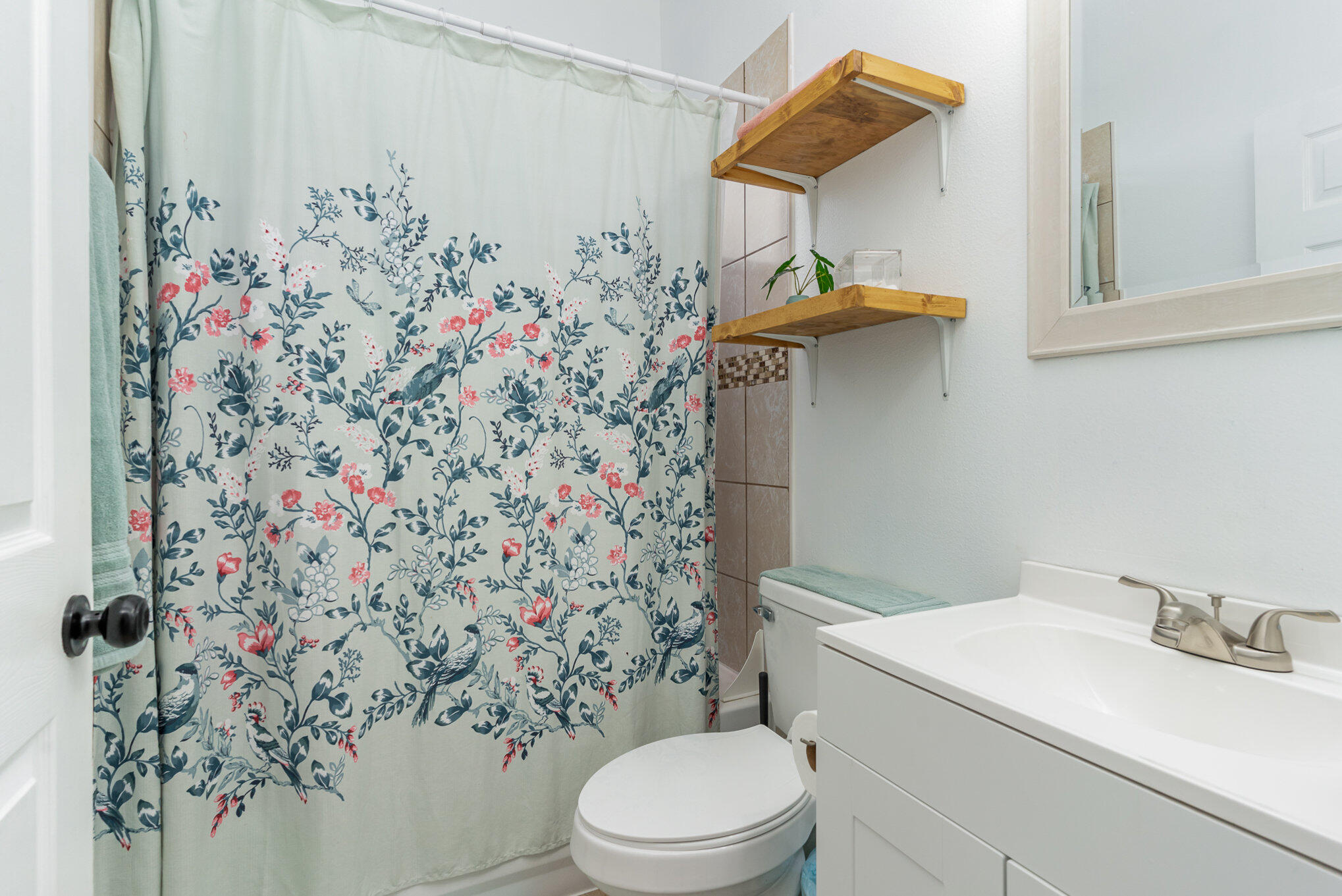 964 Shaw Circle Melbourne, FL 32940 - Photo 27 of 54 a bathroom with a toilet and a shower curtain