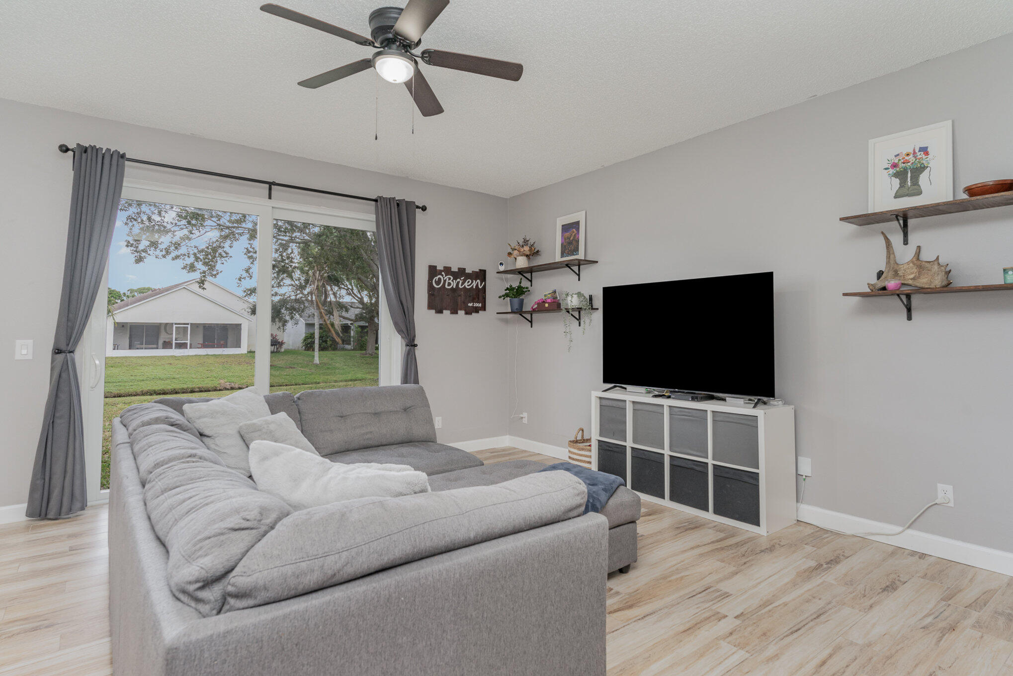964 Shaw Circle Melbourne, FL 32940 - Photo 33 of 54 a living room with furniture and a flat screen tv