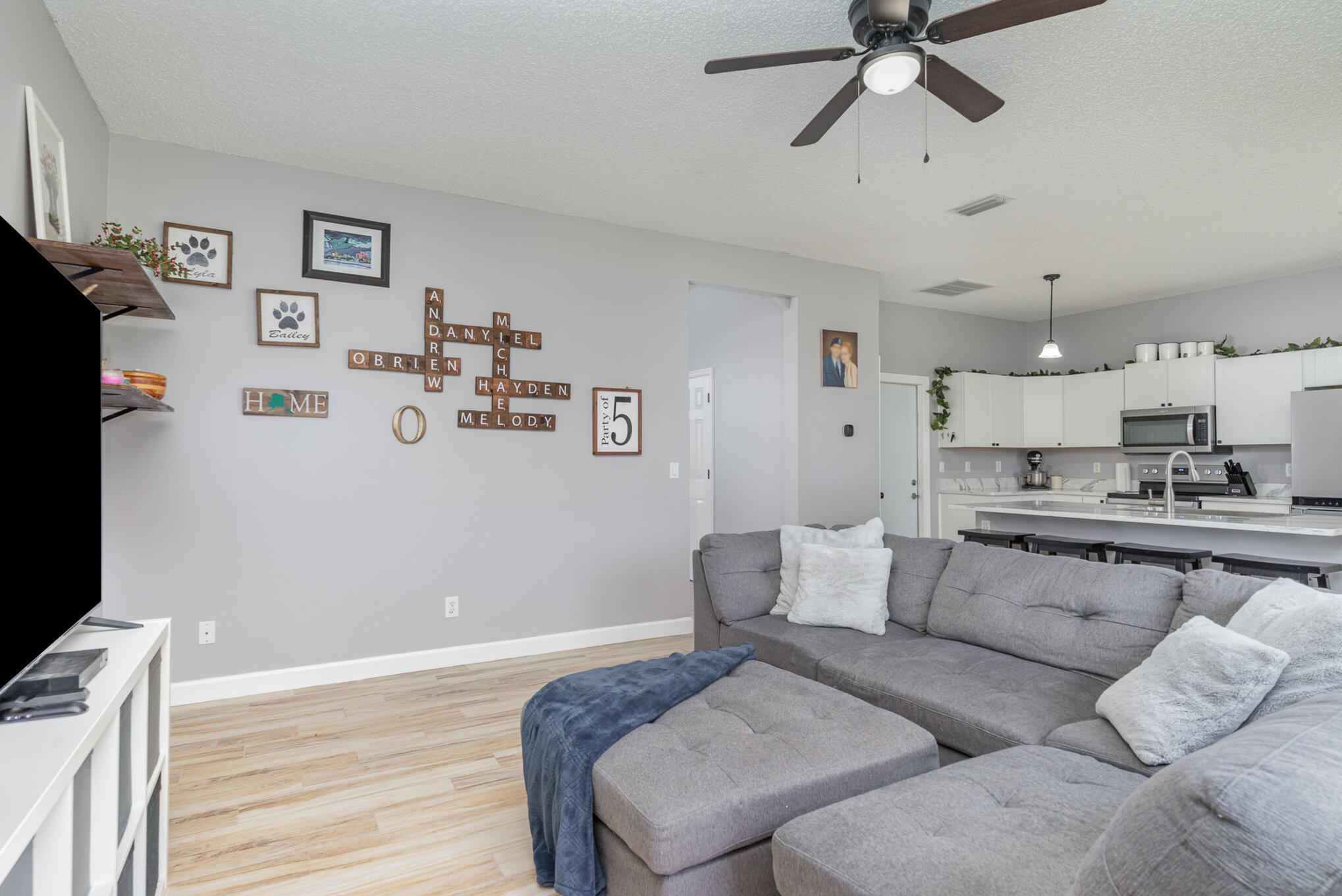 964 Shaw Circle Melbourne, FL 32940 - Photo 34 of 54 a living room with furniture and a flat screen tv