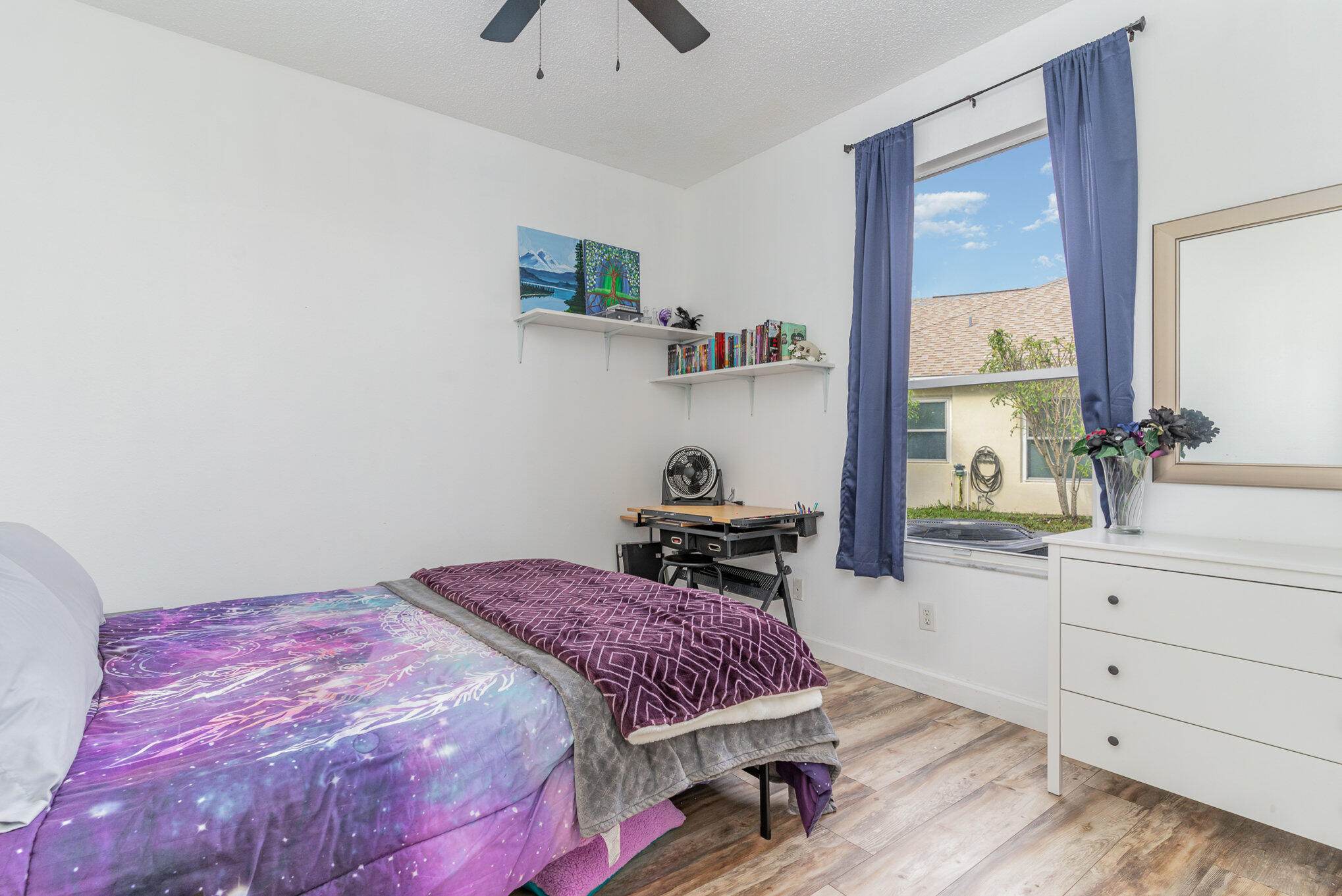 964 Shaw Circle Melbourne, FL 32940 - Photo 40 of 54 a bedroom with a bed and a dresser next to a window