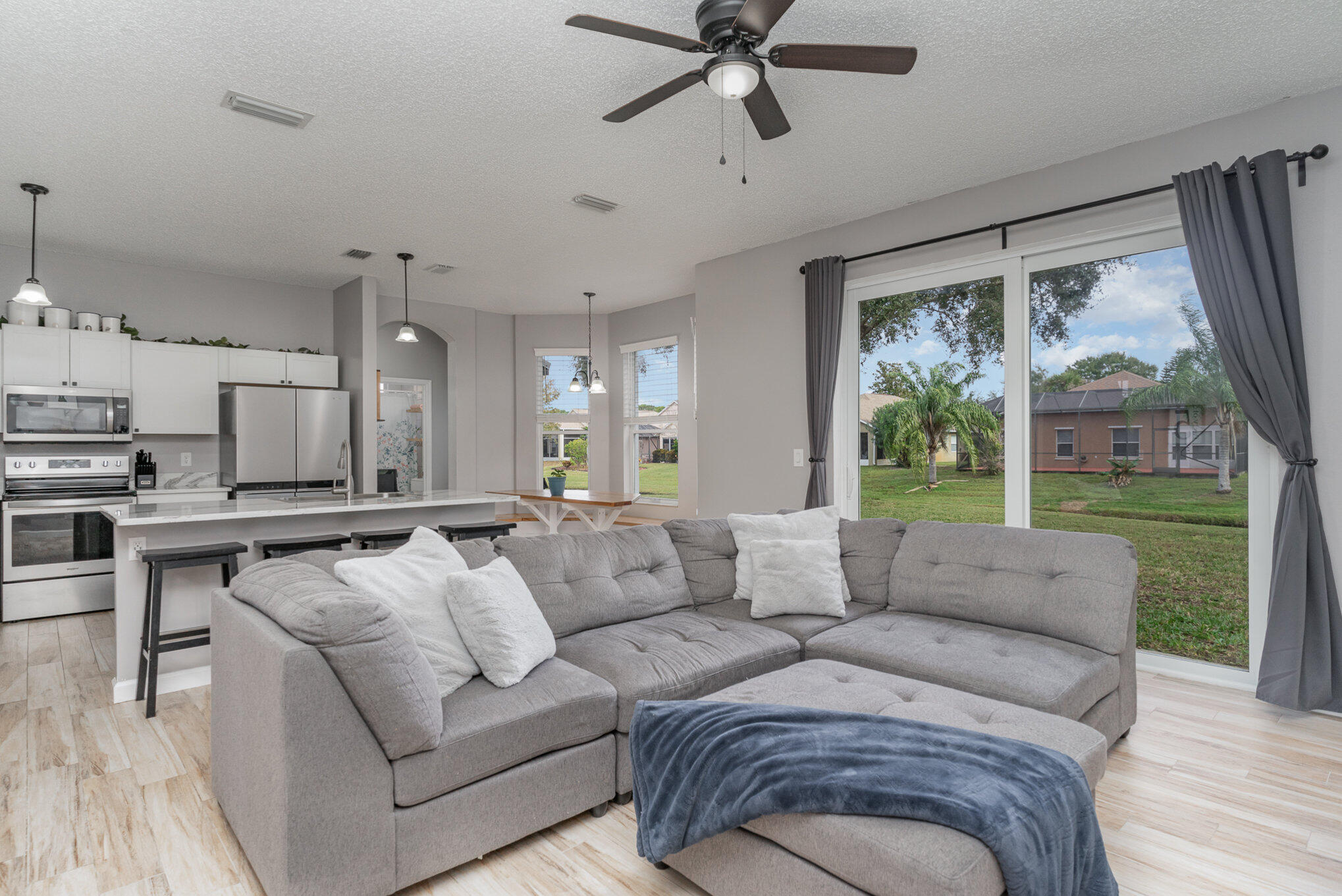 964 Shaw Circle Melbourne, FL 32940 - Photo 4 of 54 a living room with furniture and a large window