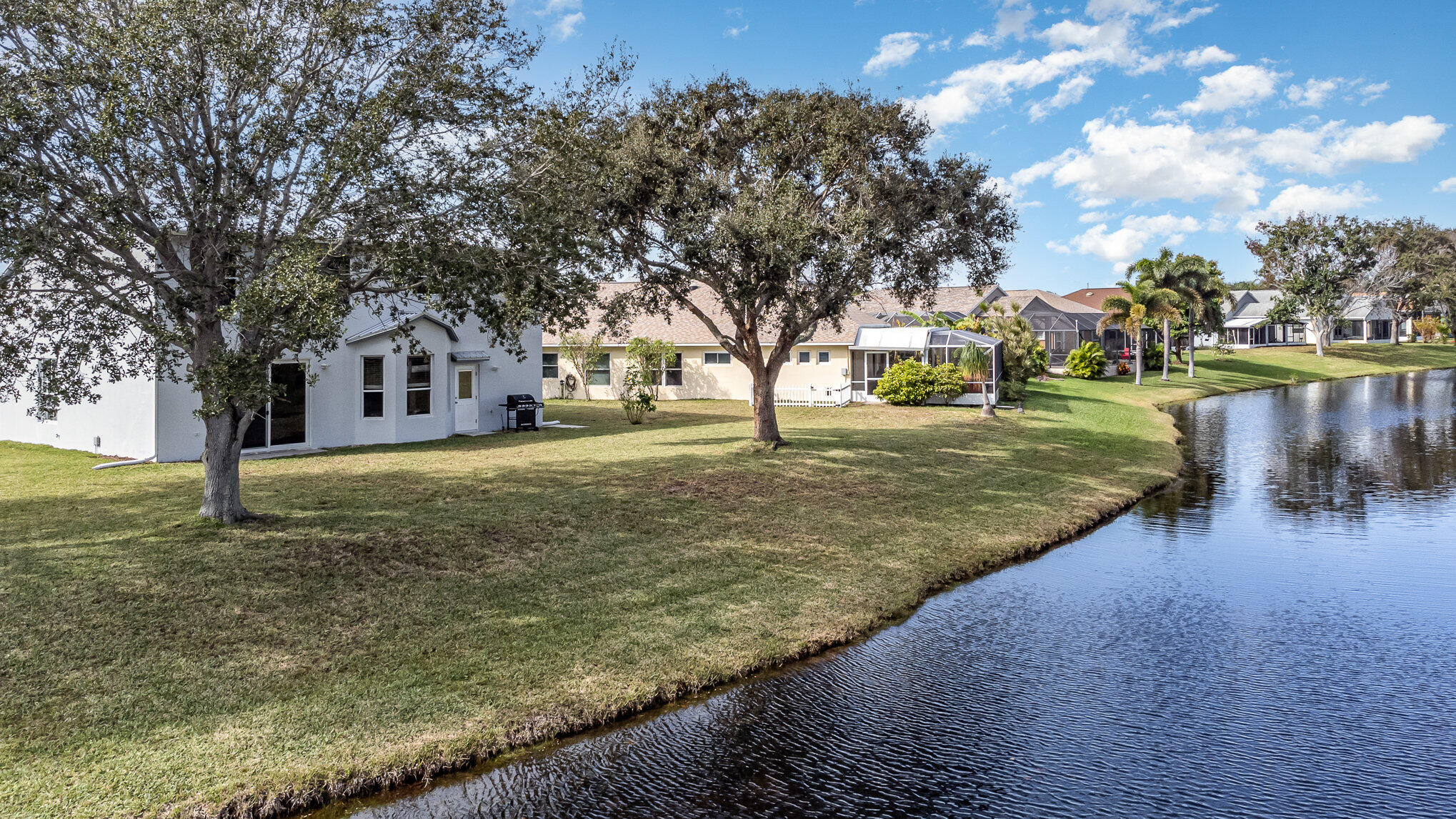 964 Shaw Circle Melbourne, FL 32940 - Photo 45 of 54 a view of a yard with a fountain in front of a house