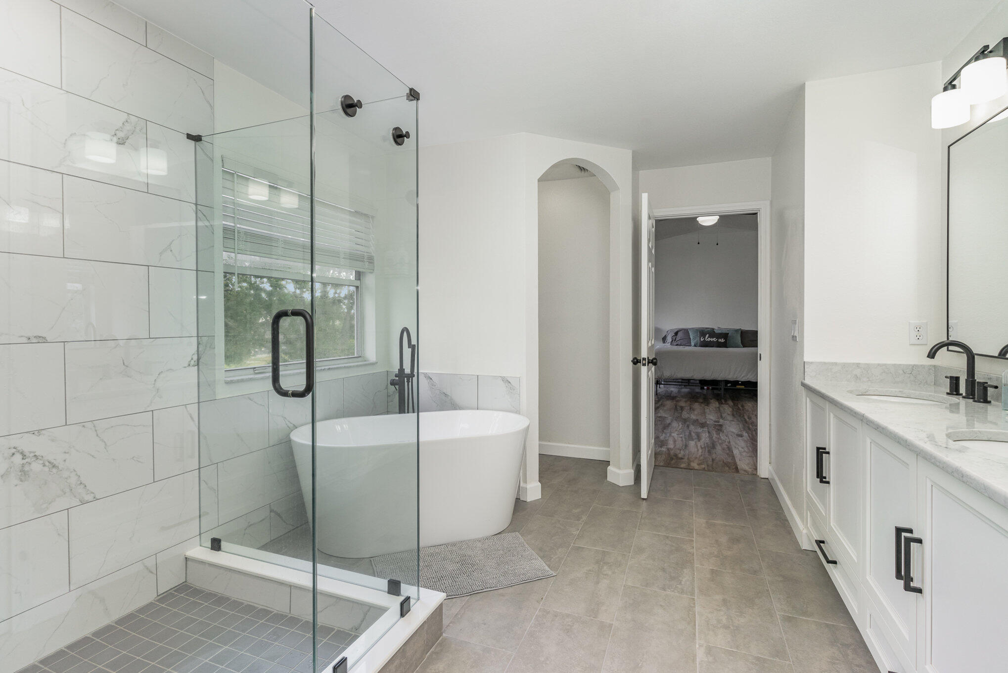 964 Shaw Circle Melbourne, FL 32940 - Photo 8 of 54 a bathroom with a tub a sink a mirror and a shower