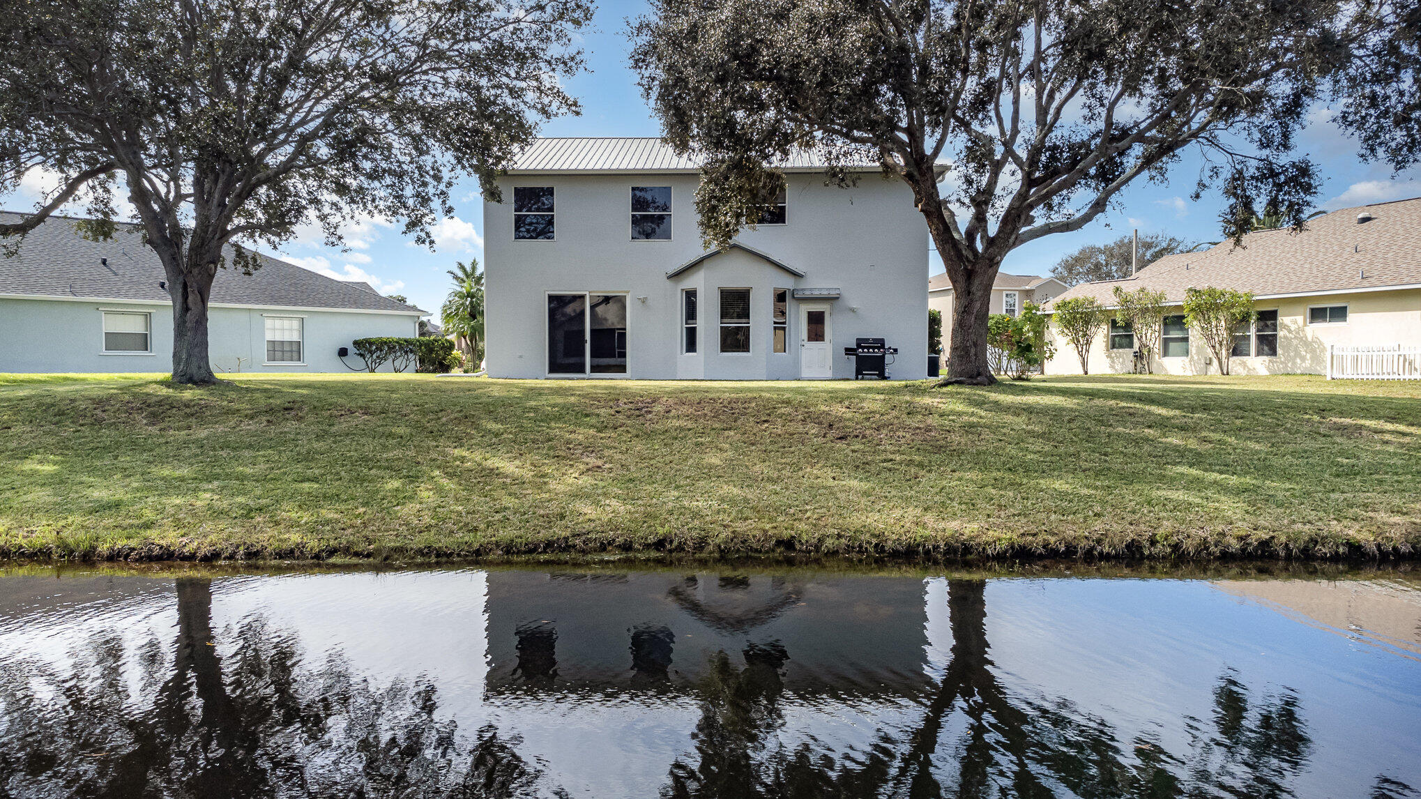 964 Shaw Circle Melbourne, FL 32940 - Photo 9 of 54 a front view of a house with a yard and a large tree