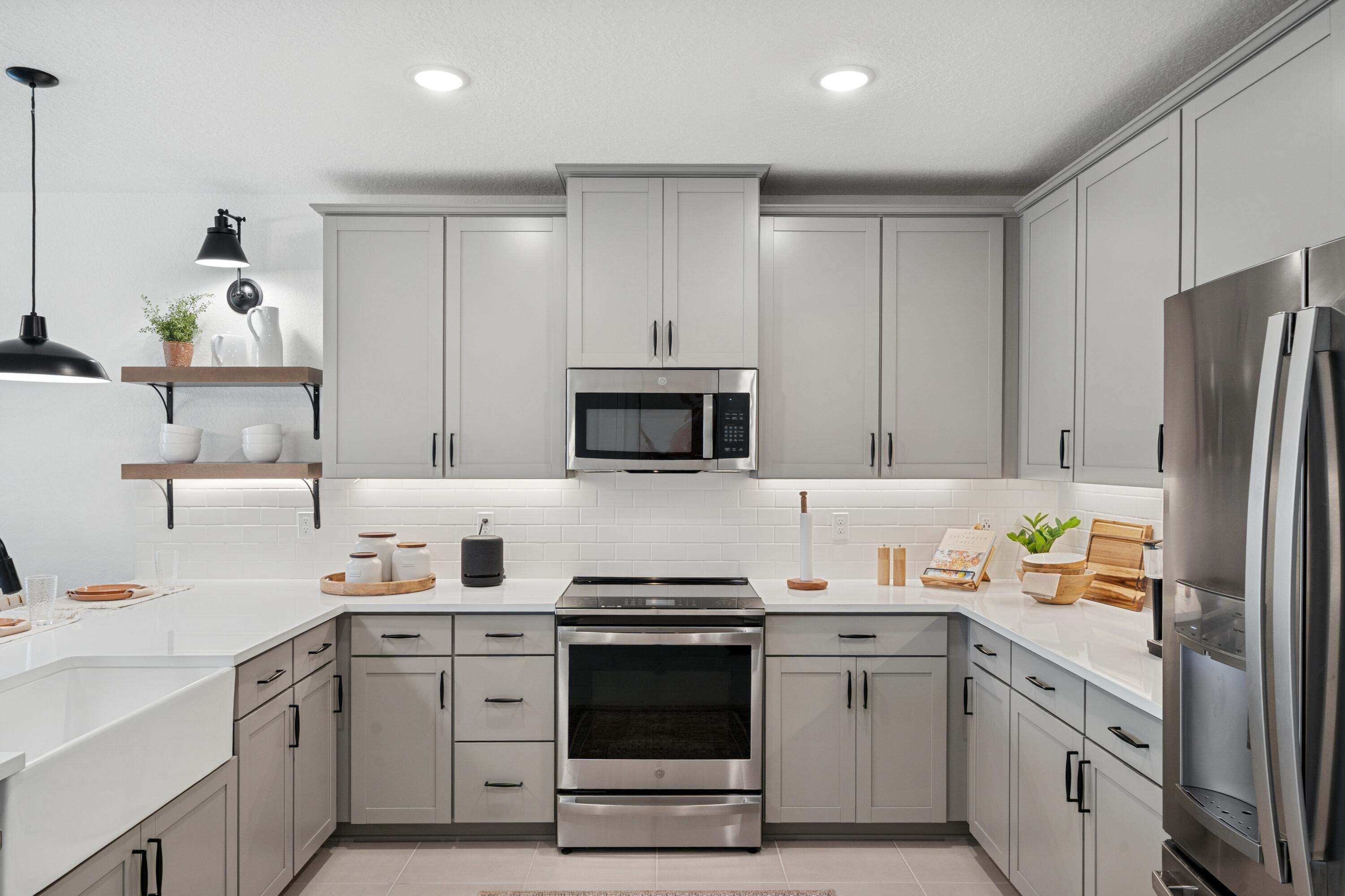 9732 Apollo Avenue, Unit 4 Fort Pierce, FL 34945 - Photo 17 of 39 a kitchen with a sink stove and refrigerator