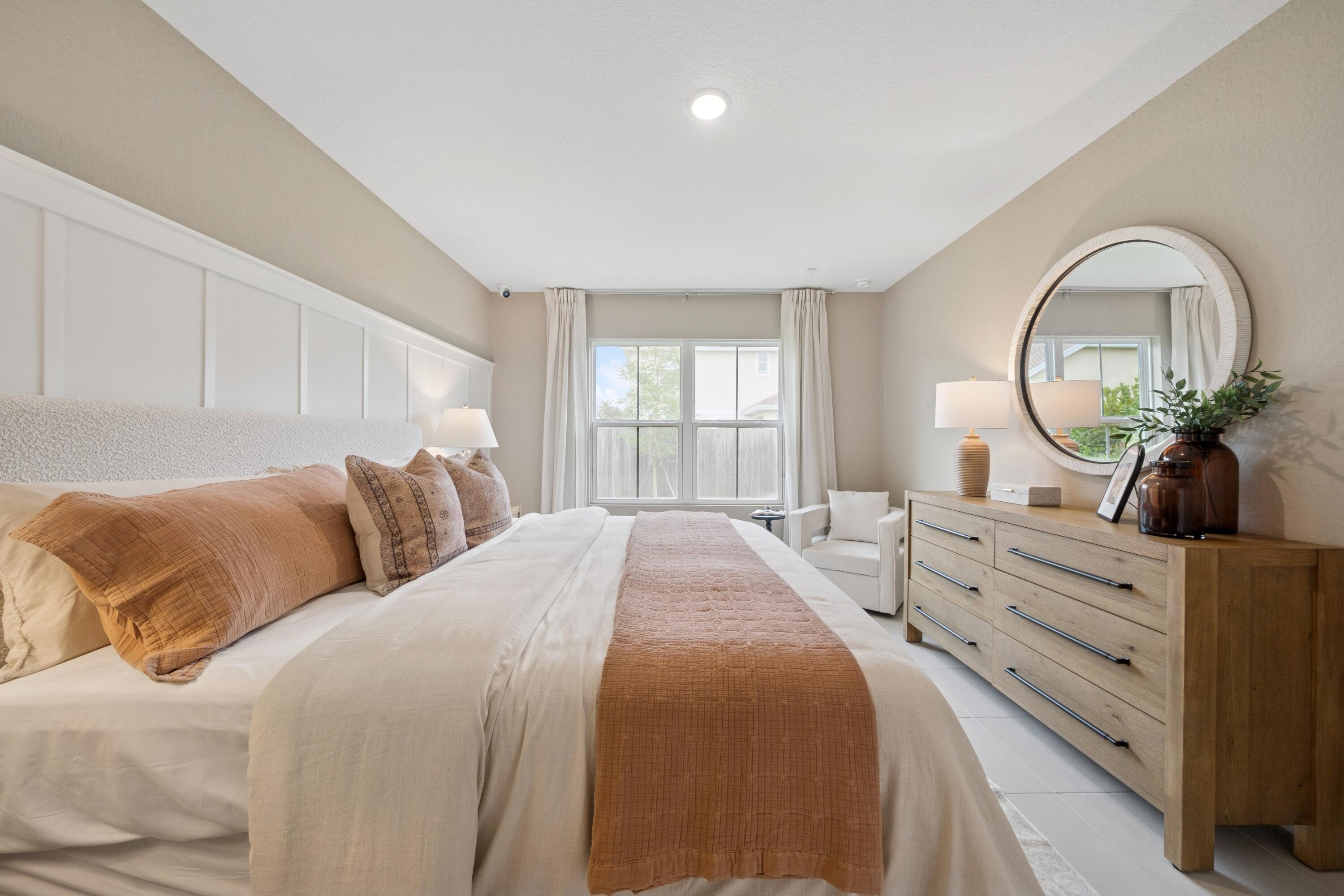 9732 Apollo Avenue, Unit 4 Fort Pierce, FL 34945 - Photo 32 of 39 a bed room with a bed and a mirror