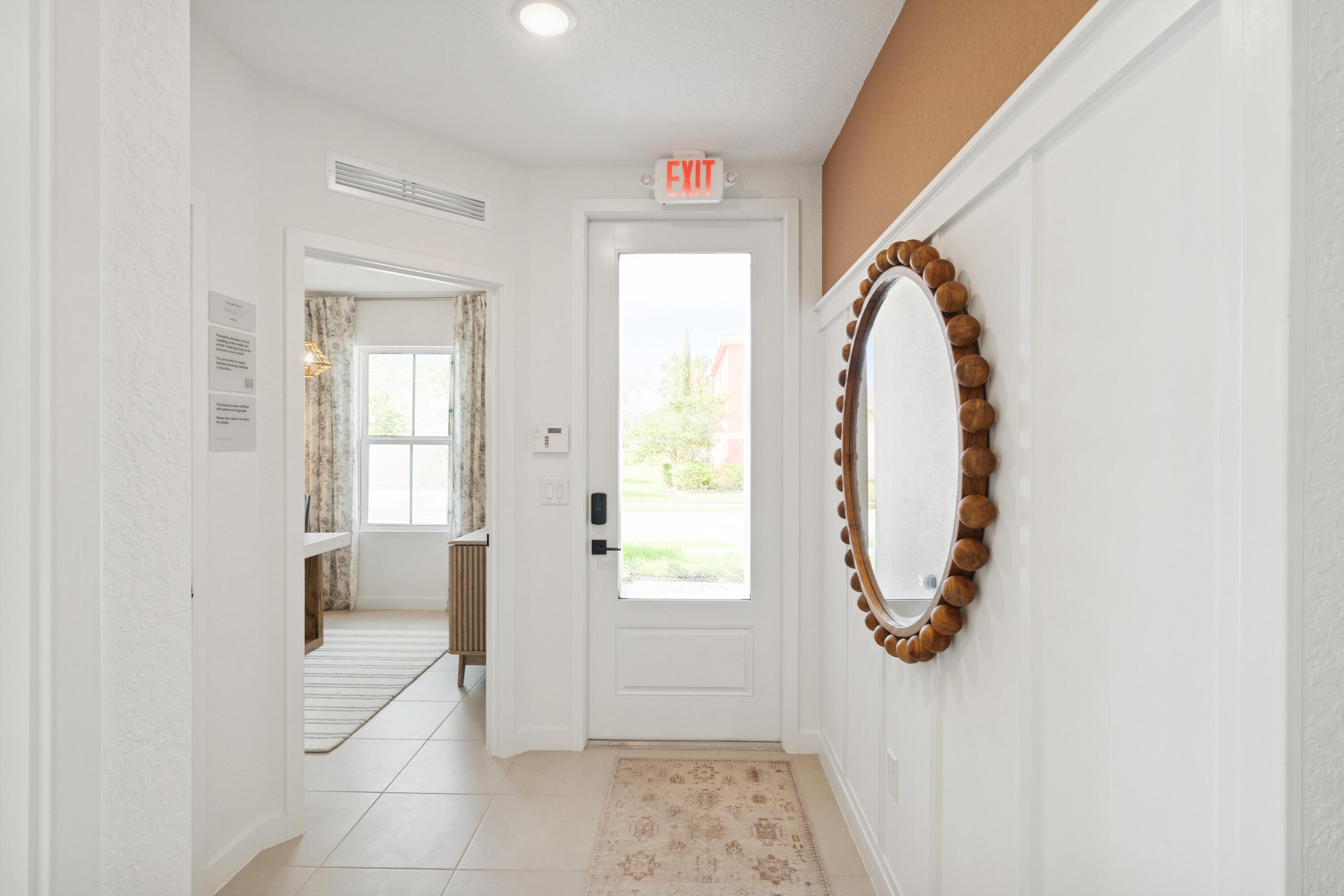 9732 Apollo Avenue, Unit 4 Fort Pierce, FL 34945 - Photo 4 of 39 a view of a hallway with wooden floor and windows