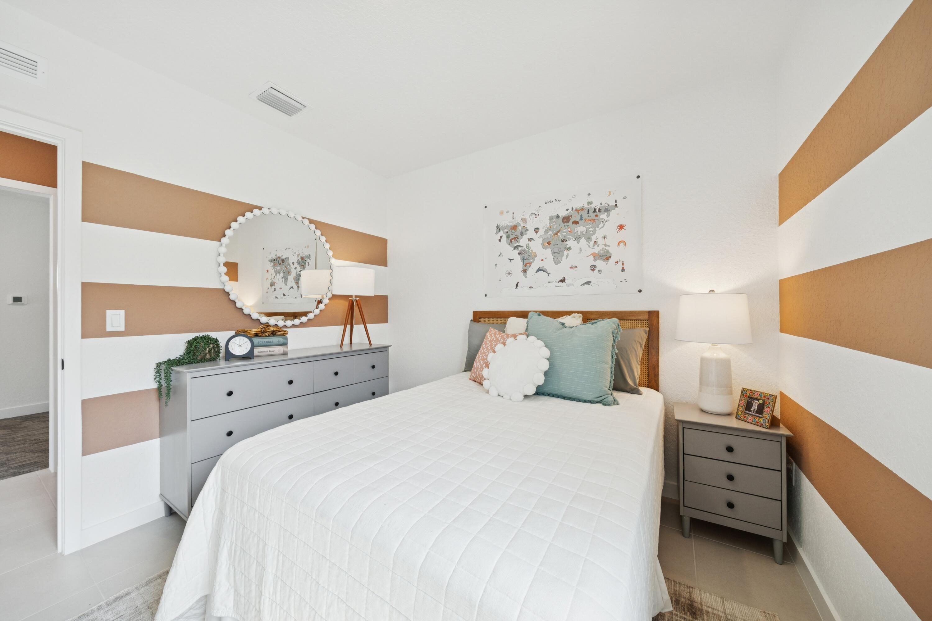 9732 Apollo Avenue, Unit 4 Fort Pierce, FL 34945 - Photo 8 of 39 a bedroom with a bed and a dresser