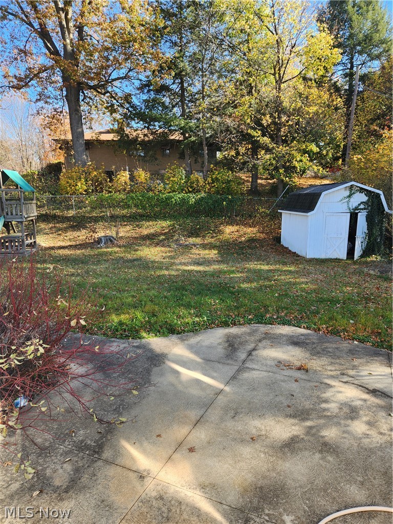 2440 Midvale Road Northwest Canton, OH 44708 - Photo 22 of 22 View of yard featuring a patio area, a playground, and a storage shed