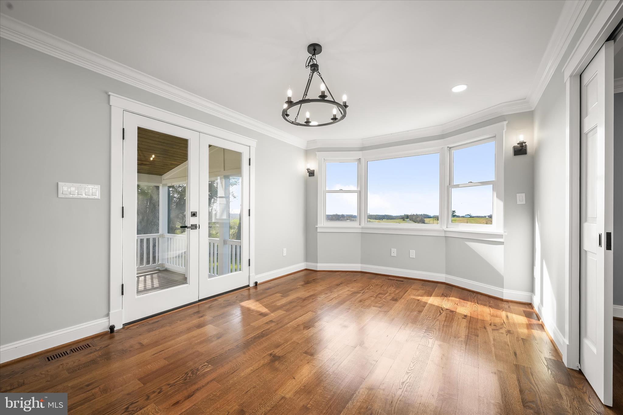 21611 Slidell Road Boyds, MD 20841 - Photo 21 of 84 a view of an empty room with wooden floor and a window