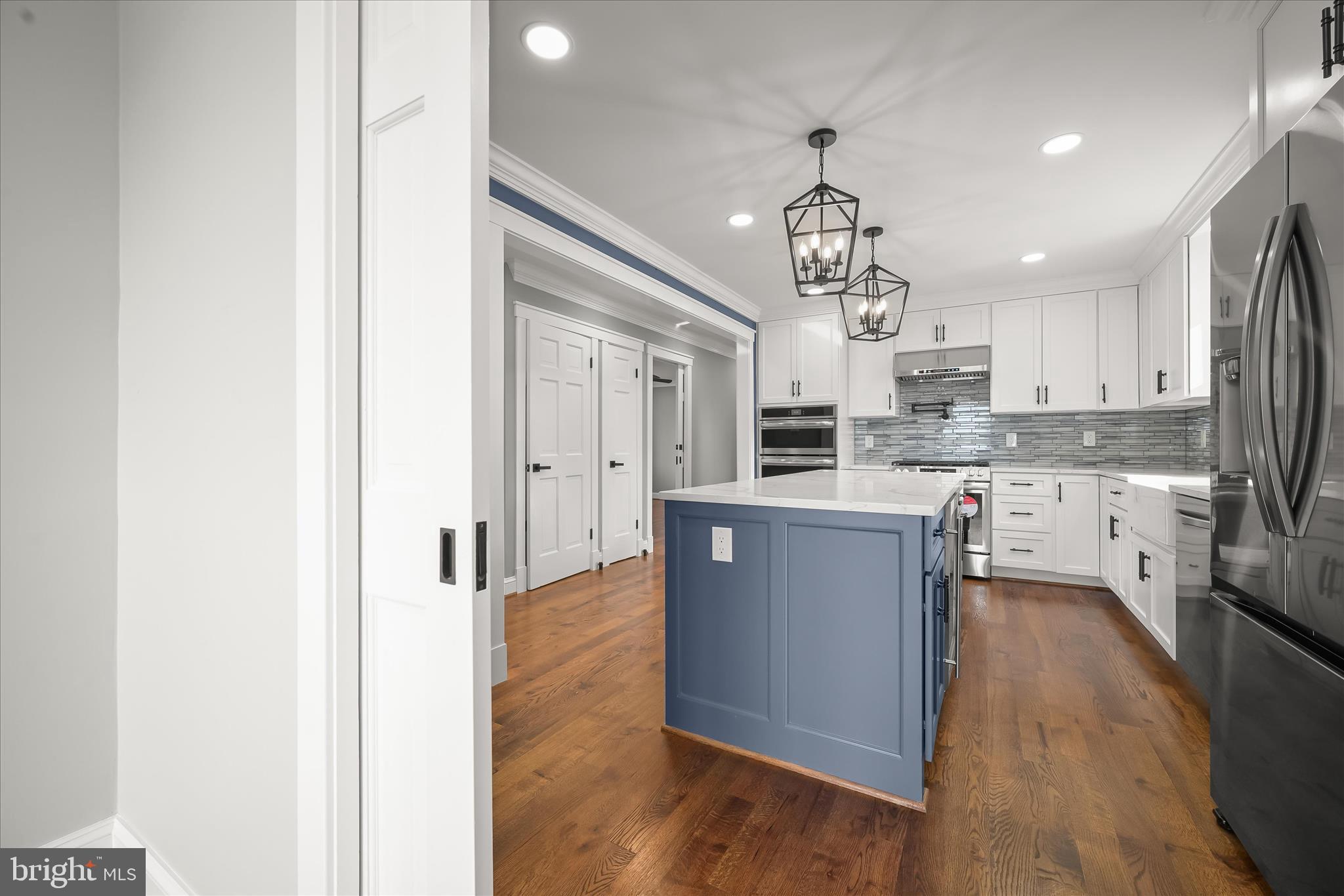 21611 Slidell Road Boyds, MD 20841 - Photo 24 of 84 a kitchen with kitchen island granite countertop wooden floors and stainless steel appliances