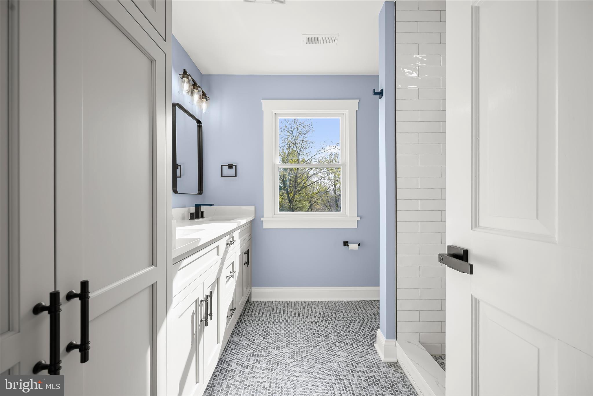 21611 Slidell Road Boyds, MD 20841 - Photo 45 of 84 a bathroom with a sink a mirror and a bathtub