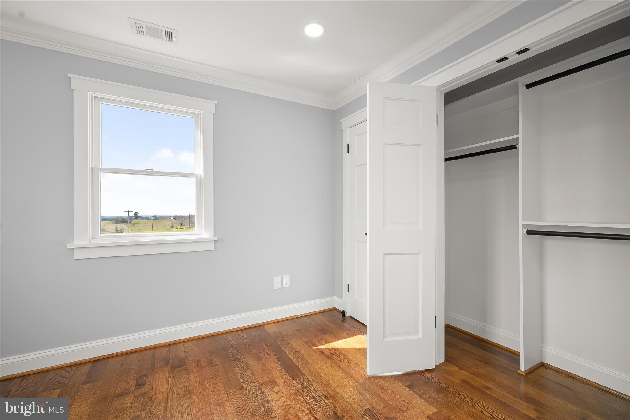 21611 Slidell Road Boyds, MD 20841 - Photo 54 of 84 a view of an empty room with wooden floor and a window