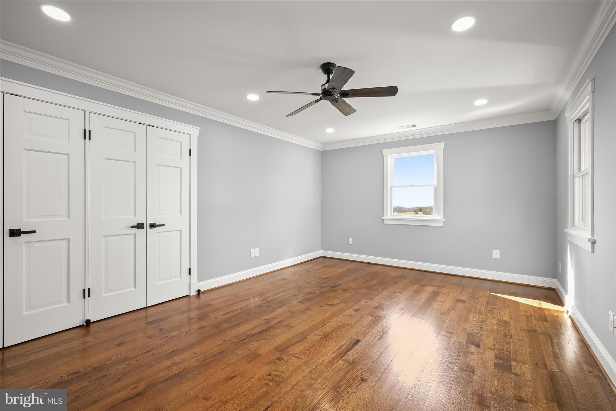 21611 Slidell Road Boyds, MD 20841 - Photo 56 of 84 an empty room with wooden floor fan and windows