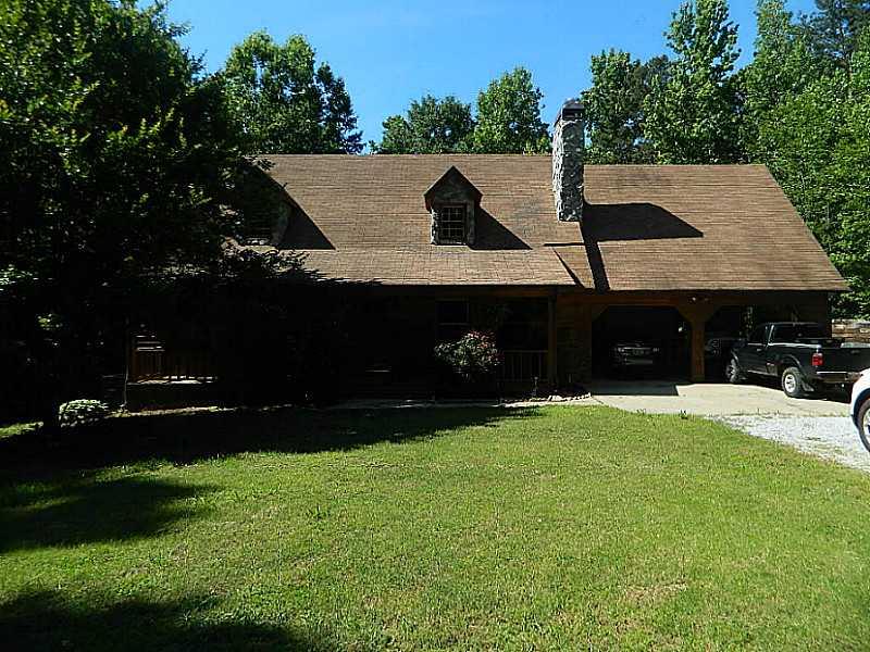 Exterior Front. Rustic cedar and rock sits on private 2.1 ac.  Secluded but only 1 mile to I-85